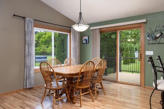 N8343 Mcwain Dr, Holland Twp, WI 54636 - dining space featuring light wood-type flooring, vaulted ceiling, and healthy amount of natural light