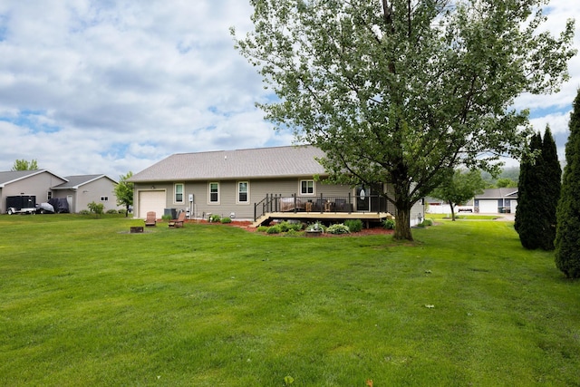 N8343 Mcwain Dr, Holland Twp, WI 54636 - back of house featuring a wooden deck, an attached garage, and a yard