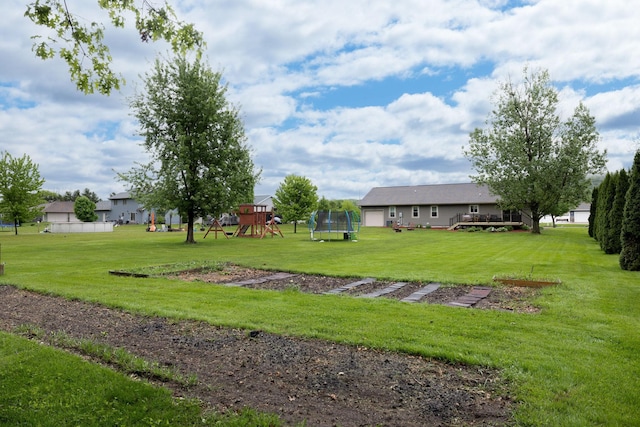 N8343 Mcwain Dr, Holland Twp, WI 54636 - view of grassy yard featuring a trampoline and a playground