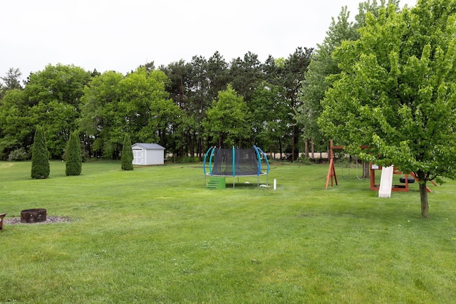 N8343 Mcwain Dr, Holland Twp, WI 54636 - view of green lawn featuring a shed, a trampoline, and view of scattered trees