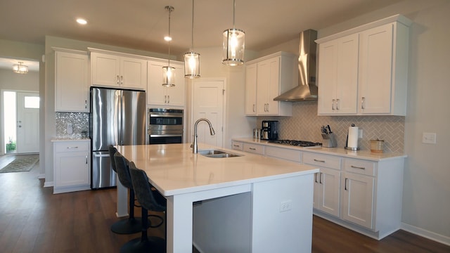 1872 Oakpointe Dr, Waconia, MN 55387 - kitchen with appliances with stainless steel finishes, wall chimney exhaust hood, backsplash, dark wood finished floors, and white cabinets