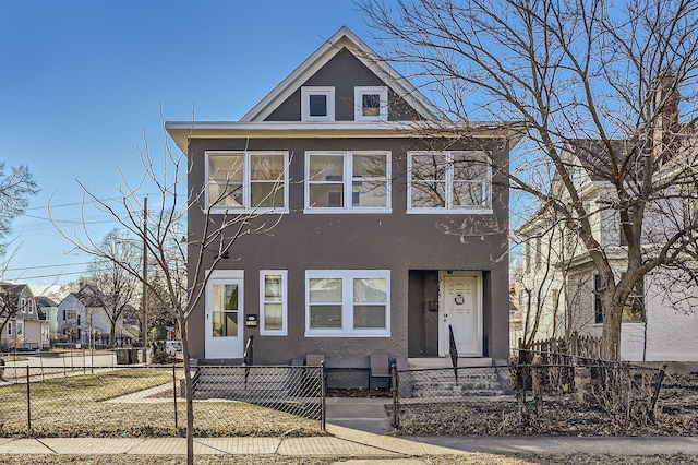 3148 Pleasant Ave, Minneapolis, MN 55408 - view of front of property with stucco siding and a fenced front yard