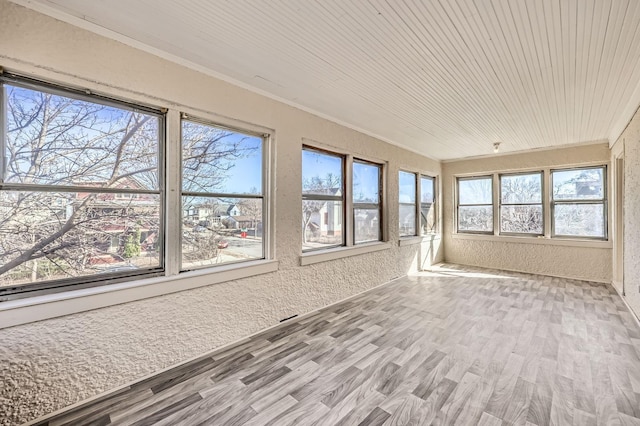 3148 Pleasant Ave, Minneapolis, MN 55408 - unfurnished sunroom featuring a textured wall, crown molding, wood finished floors, and wooden ceiling