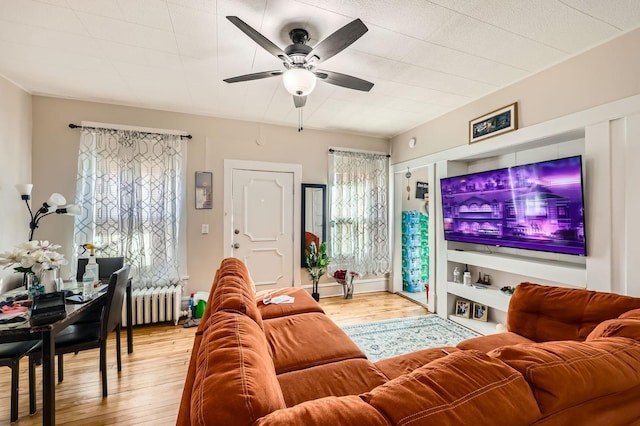 3148 Pleasant Ave, Minneapolis, MN 55408 - living room featuring radiator, wood finished floors, healthy amount of natural light, and ceiling fan