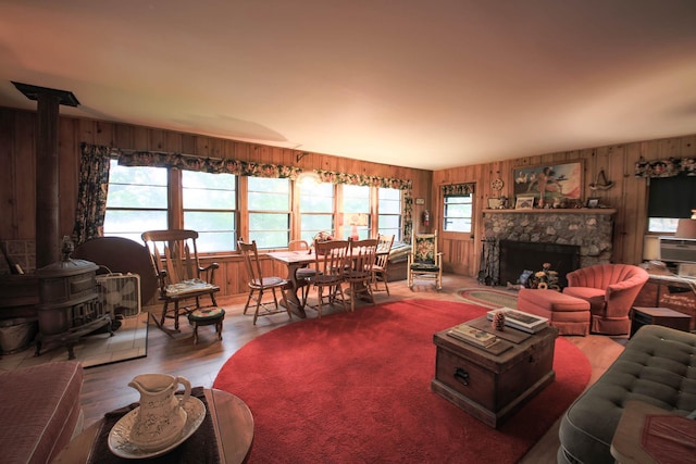 1962 81st St, Balsam Lake, WI 54810 - living area with wood walls, wood finished floors, and a stone fireplace