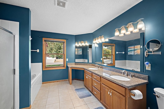 20604 Jasmine Path, Lakeville, MN 55044 - full bath featuring a bath, a textured ceiling, a stall shower, double vanity, and tile patterned floors