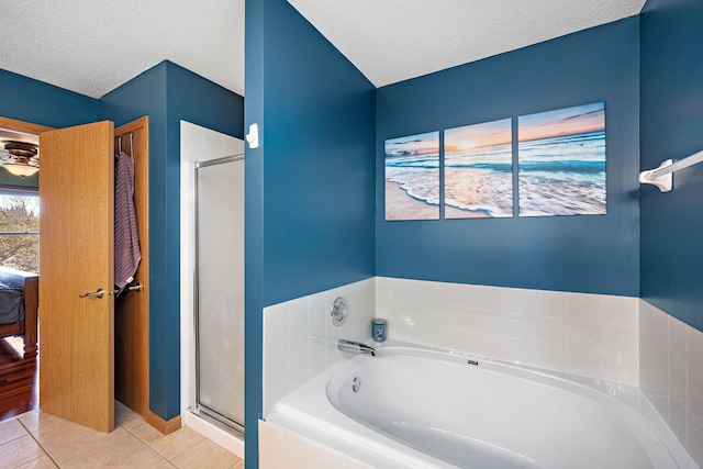 20604 Jasmine Path, Lakeville, MN 55044 - bathroom featuring tile patterned flooring, a bath, ensuite bath, a stall shower, and a textured ceiling