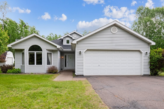 5948 Lavaque Rd, Fredenberg Twp, MN 55803 - view of front of home featuring a front yard, roof with shingles, asphalt driveway, and a garage