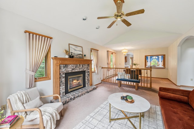 5948 Lavaque Rd, Fredenberg Twp, MN 55803 - living room with carpet floors, lofted ceiling, a ceiling fan, a brick fireplace, and arched walkways