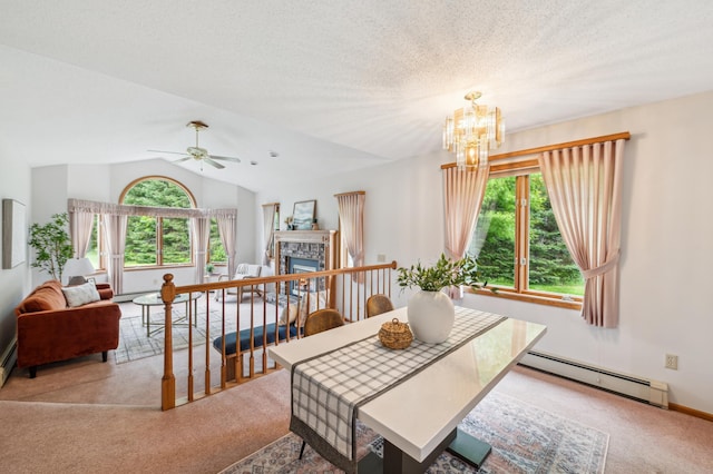5948 Lavaque Rd, Fredenberg Twp, MN 55803 - dining area featuring a baseboard heating unit, carpet, a fireplace, a chandelier, and a ceiling fan