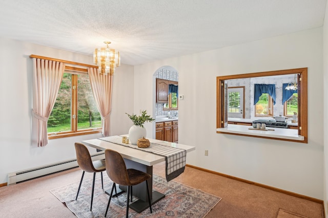 5948 Lavaque Rd, Fredenberg Twp, MN 55803 - dining area with a baseboard heating unit, light carpet, a chandelier, and arched walkways