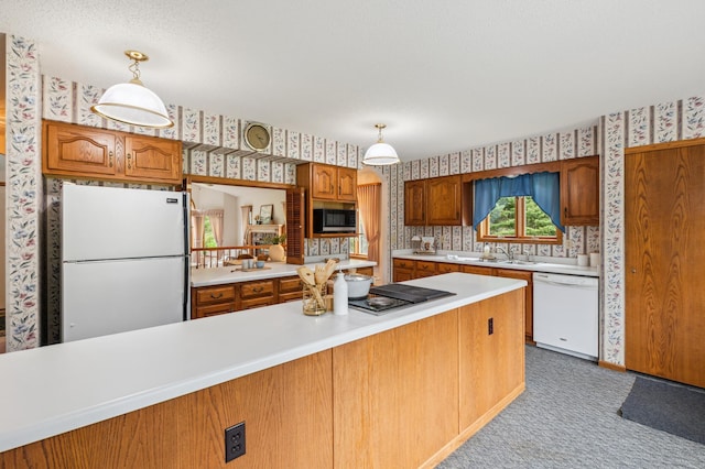 5948 Lavaque Rd, Fredenberg Twp, MN 55803 - kitchen with white appliances, wallpapered walls, light countertops, brown cabinetry, and carpet flooring