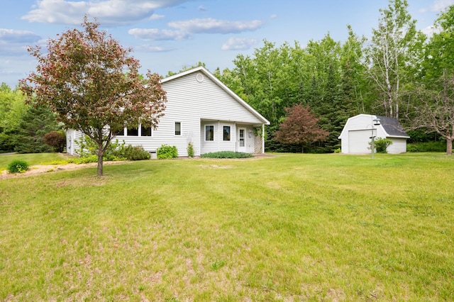 5948 Lavaque Rd, Fredenberg Twp, MN 55803 - back of house with a detached garage, a lawn, and a shed
