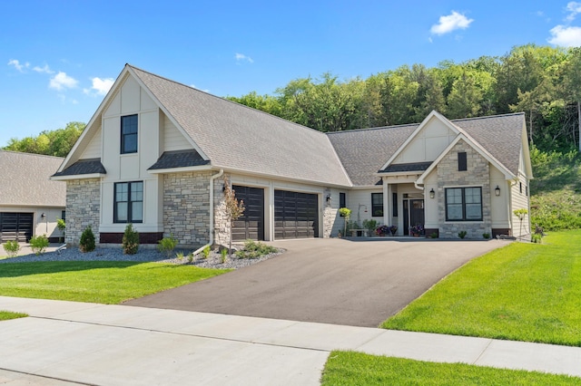 2400 Simply Living Ln, Hudson, WI 54016 - modern inspired farmhouse with stone siding, asphalt driveway, a garage, and a front yard