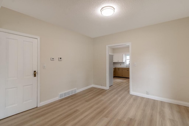 500 Sherman St, North Mankato, MN 56003 - empty room featuring light wood-style floors and a textured ceiling