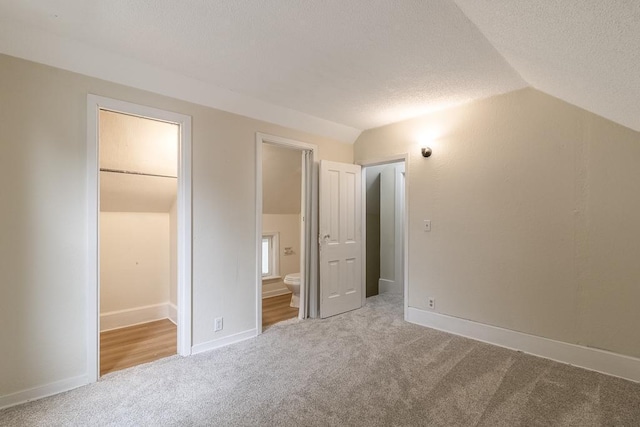 500 Sherman St, North Mankato, MN 56003 - unfurnished bedroom featuring carpet floors, lofted ceiling, a textured ceiling, and ensuite bathroom