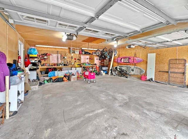 315 32nd St, Grand Rapids, MN 55744 - garage featuring a garage door opener and a workshop area