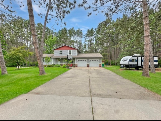 315 32nd St, Grand Rapids, MN 55744 - view of front facade with a garage, a front yard, driveway, and view of scattered trees