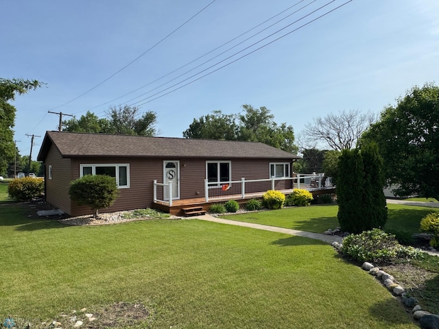 418 4th Ave W, Lisbon, ND 58054 - ranch-style house featuring a wooden deck and a front yard