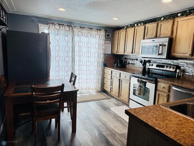 418 4th Ave W, Lisbon, ND 58054 - kitchen featuring stainless steel range with electric stovetop, dark countertops, wood finished floors, a textured ceiling, and tasteful backsplash