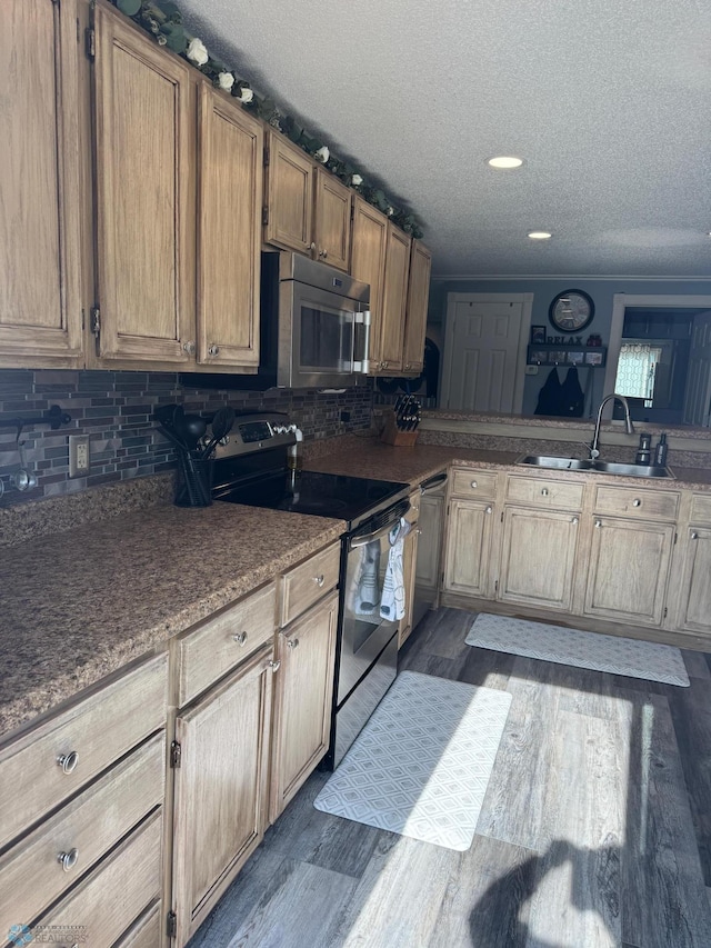 418 4th Ave W, Lisbon, ND 58054 - kitchen with appliances with stainless steel finishes, a textured ceiling, backsplash, and dark wood-type flooring