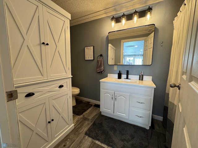 418 4th Ave W, Lisbon, ND 58054 - full bathroom featuring wood finished floors, vanity, and a textured ceiling
