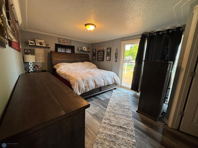 418 4th Ave W, Lisbon, ND 58054 - bedroom featuring access to outside, a textured ceiling, and wood finished floors