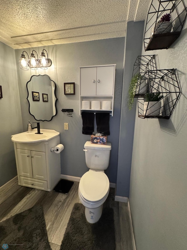 418 4th Ave W, Lisbon, ND 58054 - half bath featuring vanity, wood finished floors, and a textured ceiling