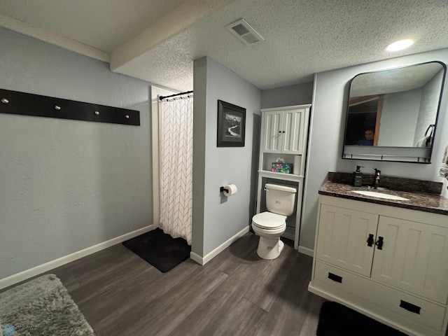418 4th Ave W, Lisbon, ND 58054 - full bath with wood finished floors, vanity, a shower with curtain, and a textured ceiling