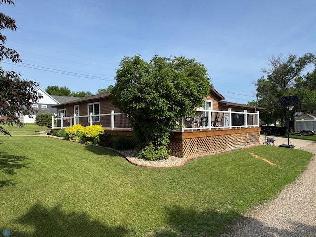 418 4th Ave W, Lisbon, ND 58054 - view of side of property featuring a lawn and a deck