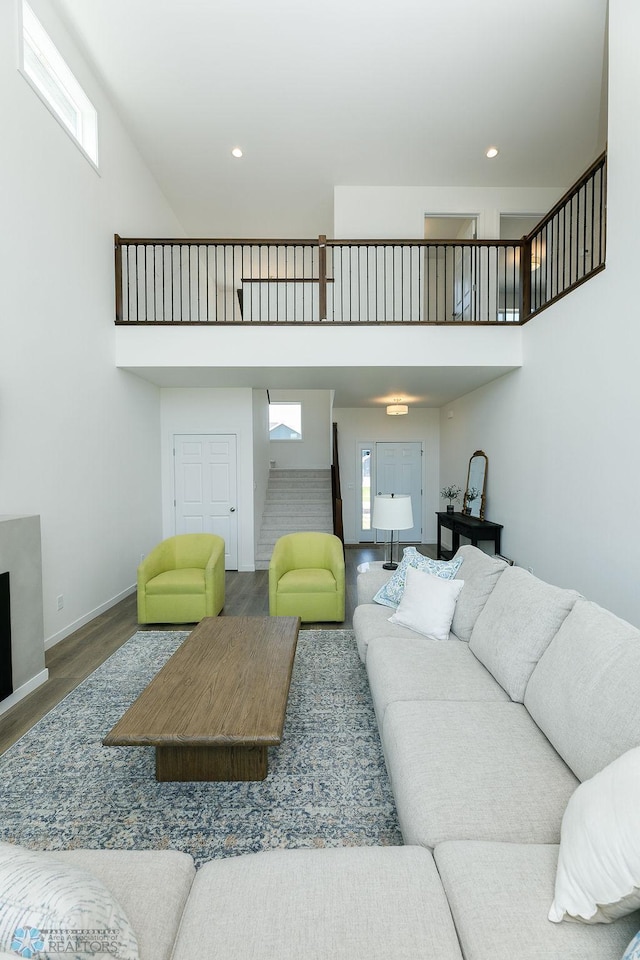7328 Aquiline Dr S, Fargo, ND 58104 - living area with wood finished floors, a high ceiling, stairs, and recessed lighting