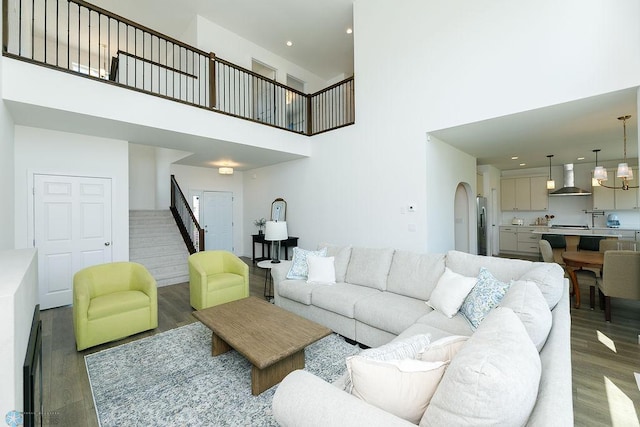 7328 Aquiline Dr S, Fargo, ND 58104 - living room featuring a towering ceiling, wood finished floors, stairway, and recessed lighting
