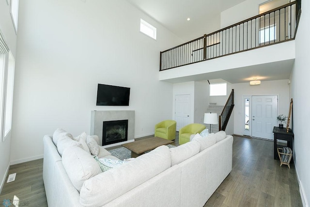 7328 Aquiline Dr S, Fargo, ND 58104 - living room featuring a high ceiling, stairway, wood finished floors, healthy amount of natural light, and recessed lighting