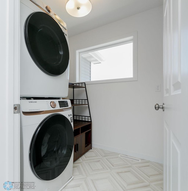 7328 Aquiline Dr S, Fargo, ND 58104 - laundry area with stacked washer / dryer and baseboards