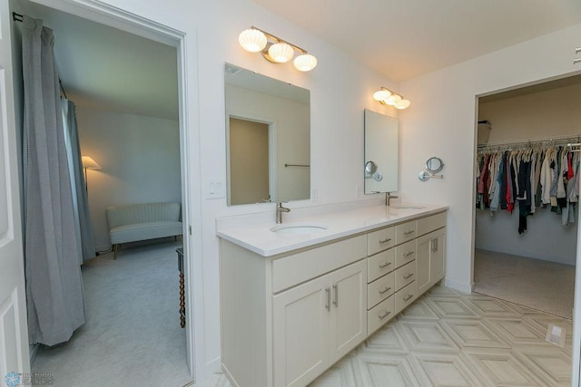 7328 Aquiline Dr S, Fargo, ND 58104 - full bathroom with double vanity, connected bathroom, and a spacious closet