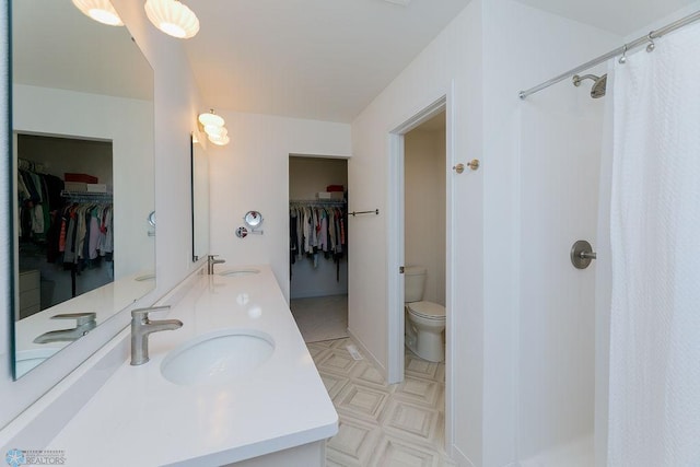 7328 Aquiline Dr S, Fargo, ND 58104 - full bathroom with a walk in closet, double vanity, and a shower with curtain