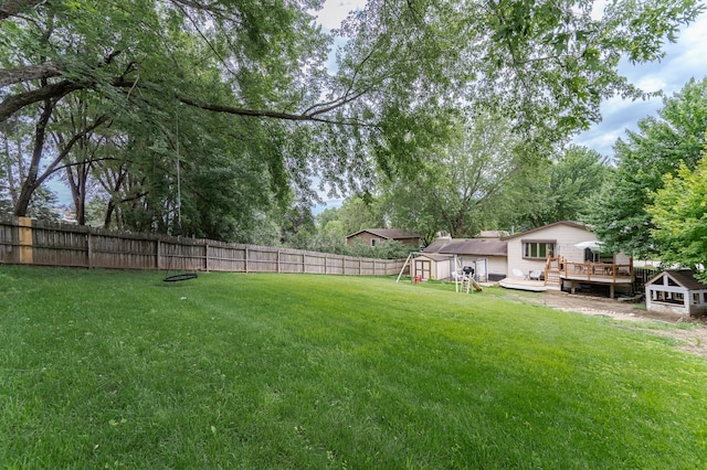 5520 25th Ave NW, Rochester, MN 55901 - fenced backyard featuring a wooden deck and a storage unit