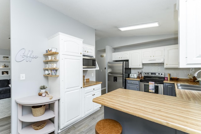 5520 25th Ave NW, Rochester, MN 55901 - kitchen with appliances with stainless steel finishes, open shelves, under cabinet range hood, vaulted ceiling, and white cabinetry