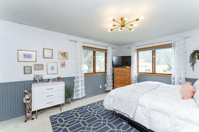 5520 25th Ave NW, Rochester, MN 55901 - bedroom featuring a chandelier, carpet flooring, and a wainscoted wall