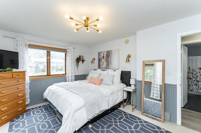 5520 25th Ave NW, Rochester, MN 55901 - bedroom with a chandelier, multiple windows, and wainscoting