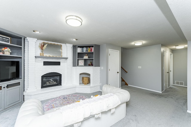 5520 25th Ave NW, Rochester, MN 55901 - living room with carpet, a brick fireplace, stairs, and a textured ceiling