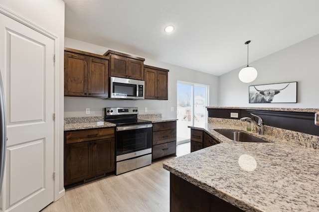 945 Breckenridge Ln, Montrose, MN 55363 - kitchen with appliances with stainless steel finishes, vaulted ceiling, light wood-style floors, dark brown cabinetry, and pendant lighting