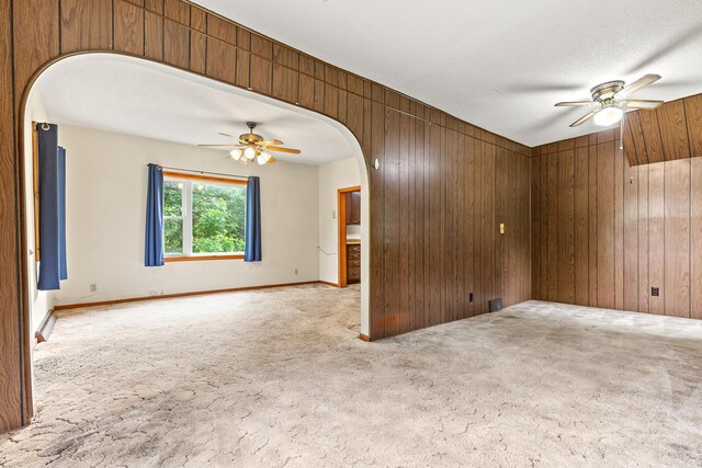 W3767 750th Ave, Gilman Twp, WI 54767 - carpeted empty room featuring a ceiling fan, arched walkways, and wooden walls