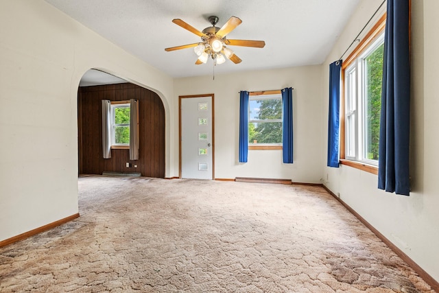 W3767 750th Ave, Gilman Twp, WI 54767 - unfurnished room with arched walkways, plenty of natural light, a ceiling fan, and carpet floors