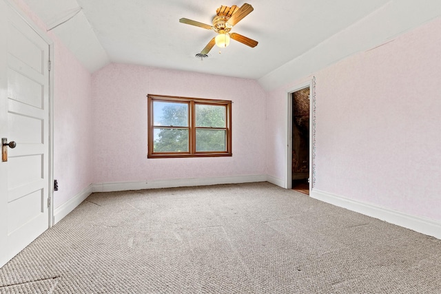 W3767 750th Ave, Gilman Twp, WI 54767 - unfurnished bedroom with lofted ceiling, light carpet, and a ceiling fan