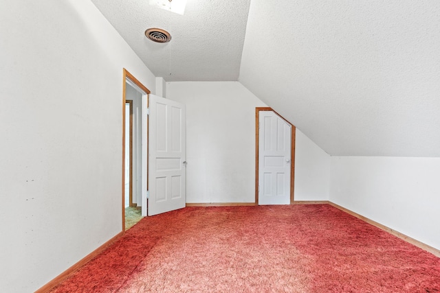 W3767 750th Ave, Gilman Twp, WI 54767 - bonus room featuring a textured ceiling, vaulted ceiling, and carpet flooring