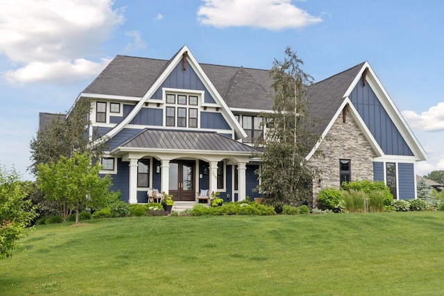 7568 Glen Alcove, Woodbury, MN 55129 - view of front facade with board and batten siding, covered porch, a standing seam roof, and a front lawn