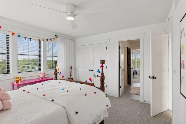 7568 Glen Alcove, Woodbury, MN 55129 - bedroom featuring multiple windows, light carpet, a closet, and a ceiling fan