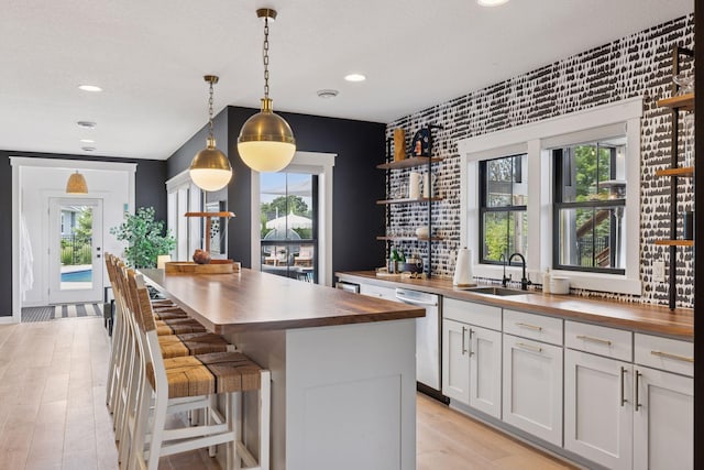 7568 Glen Alcove, Woodbury, MN 55129 - kitchen featuring wood counters, open shelves, stainless steel dishwasher, recessed lighting, and light wood-style floors
