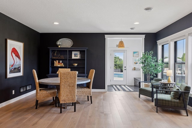 7568 Glen Alcove, Woodbury, MN 55129 - dining space with wood finished floors, recessed lighting, and a textured ceiling